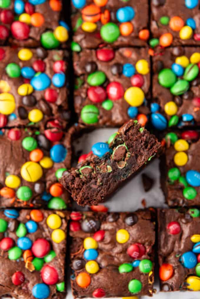 An image of an M&M brownie on its side surrounded by more brownies.
