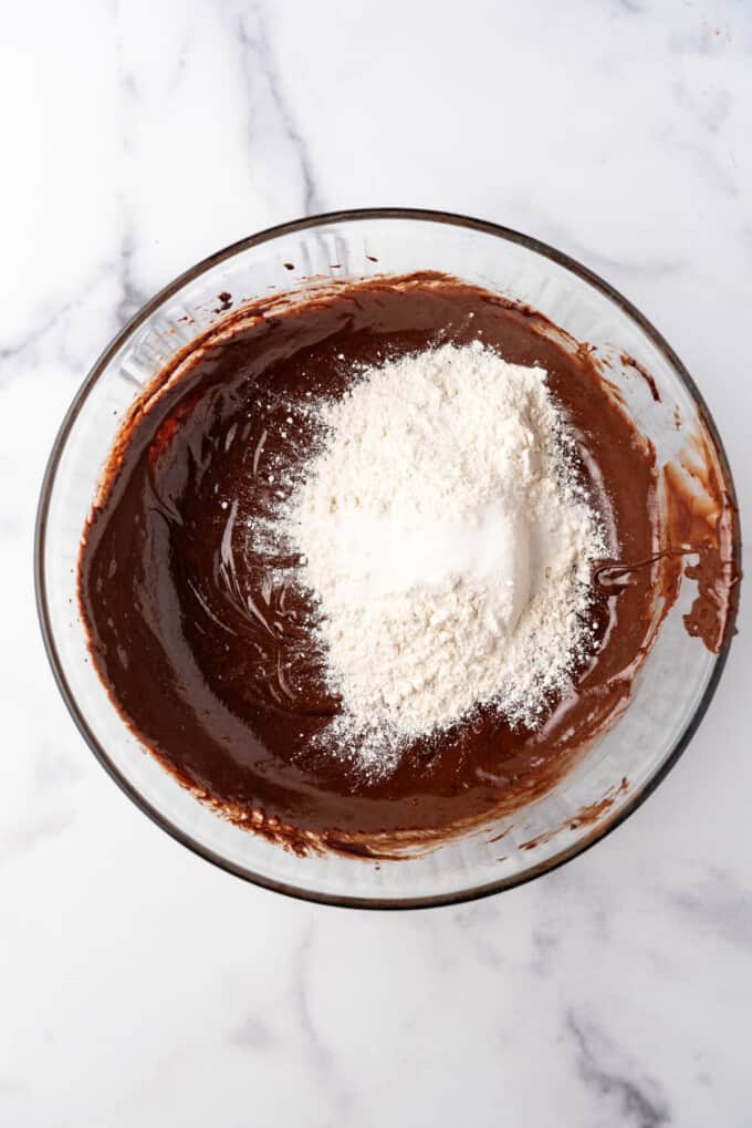 Adding flour to brownie batter.