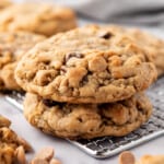 Two stacked peanut butter oatmeal chocolate chip cookies.