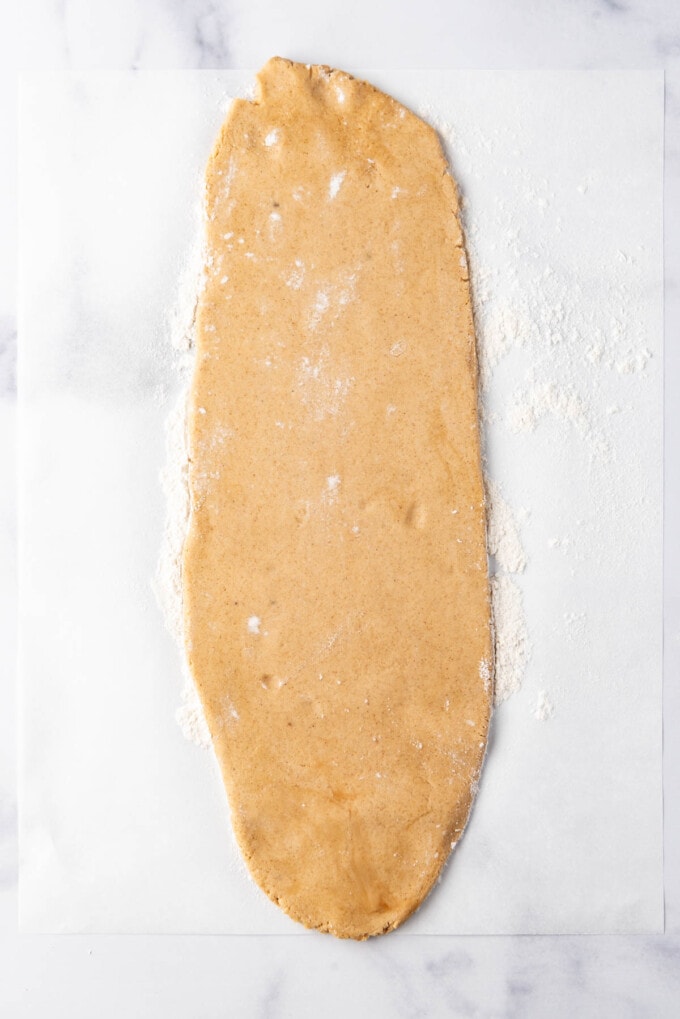 Rolled out cookie dough on a white surface.