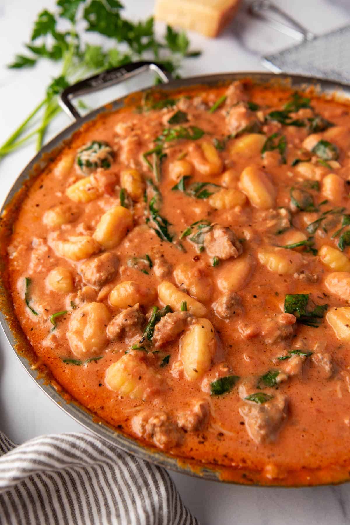 An image of a skillet full of creamy sausage gnocchi.