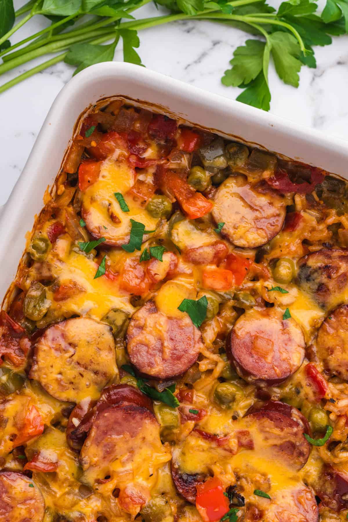 An overhead image of sausage and rice casserole in a white pan.