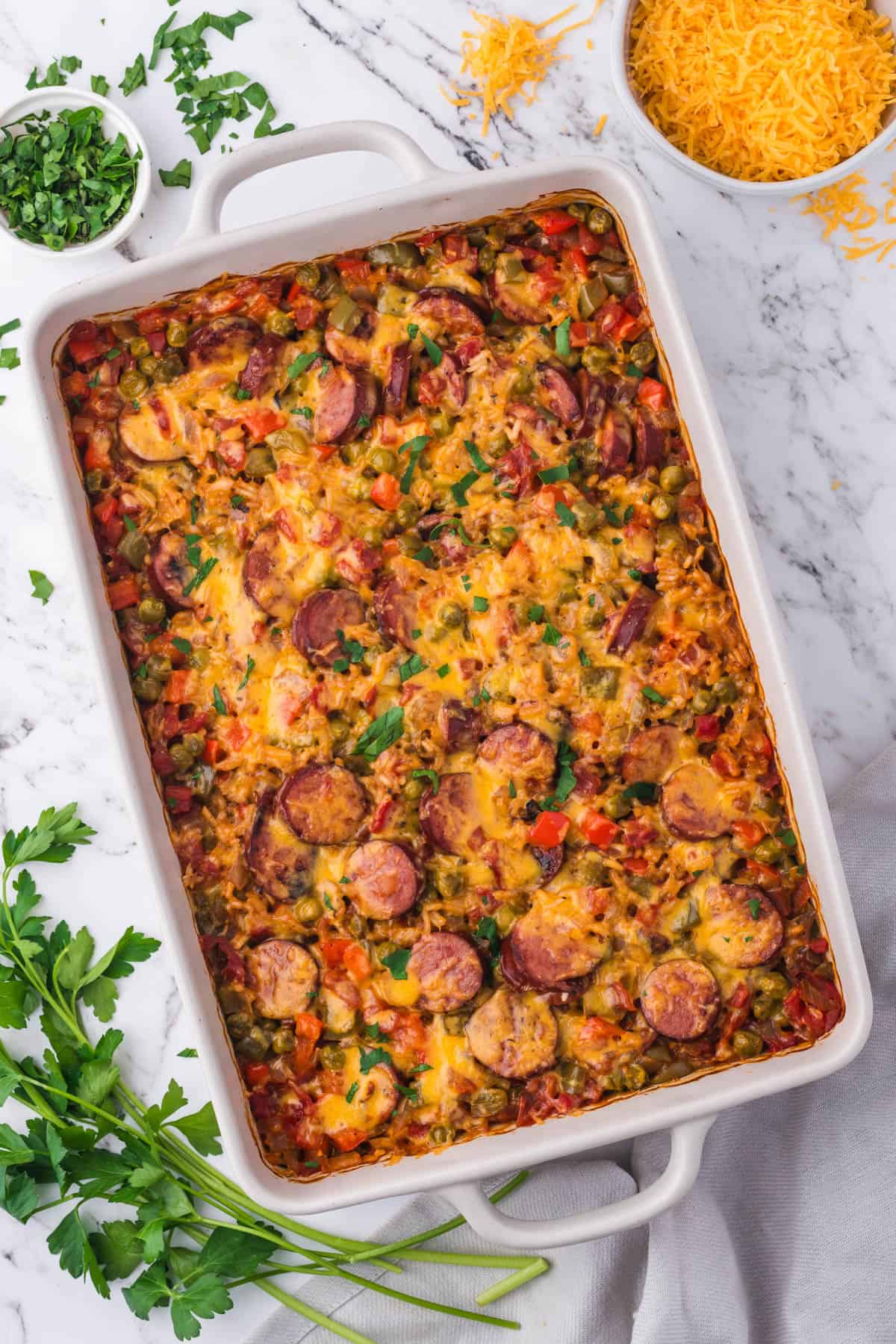 An overhead image of baked smoked sausage and rice casserole.