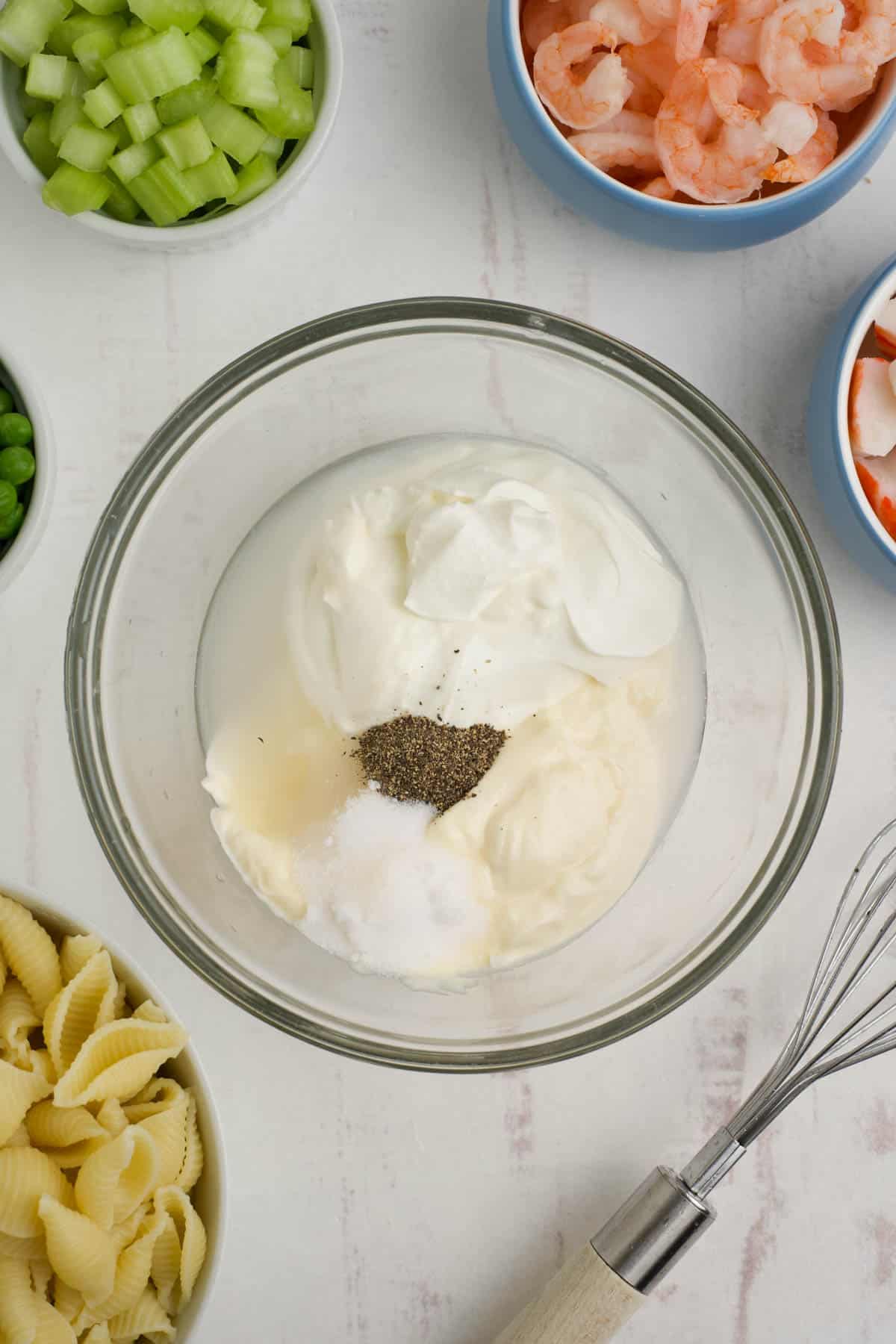 Combining creamy dressing ingredients in a bowl.