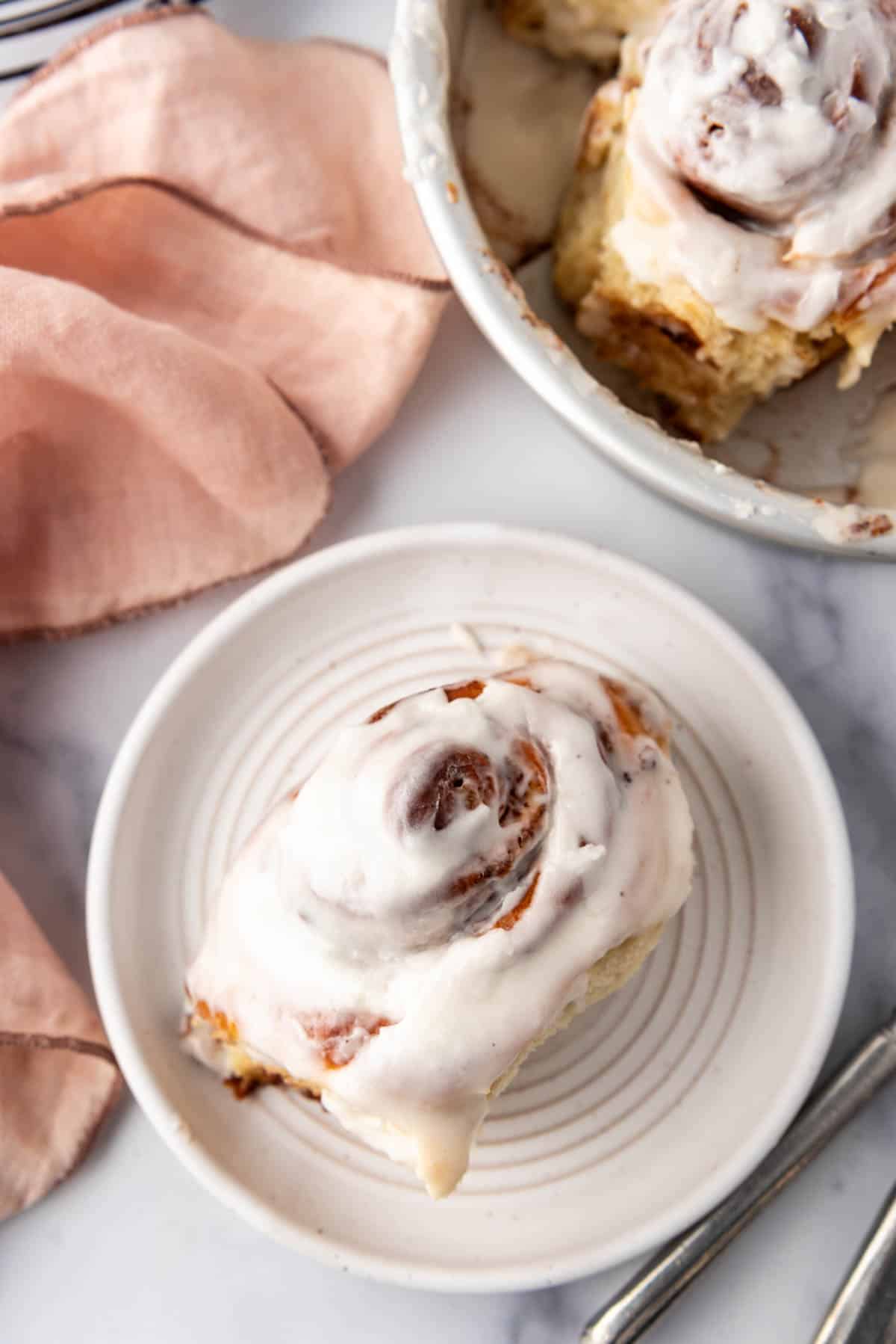 An overhead image of a cinnamon roll on a plate.