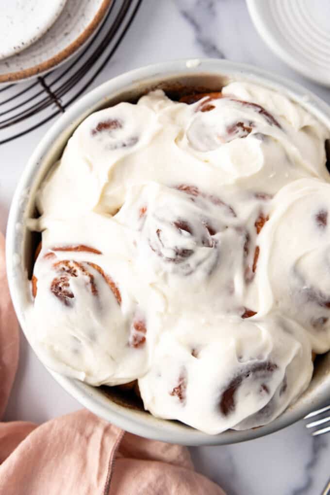 An overhead image of cinnamon rolls frosted with cream cheese icing.
