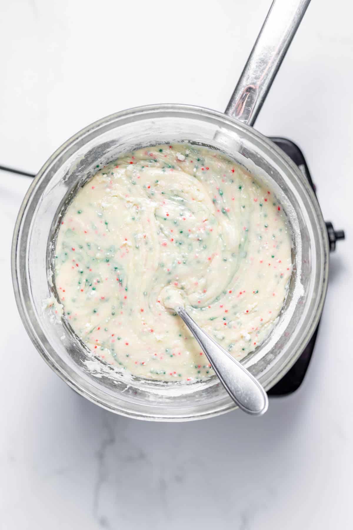 Sugar cookie fudge mixture in a glass bowl double boiler.