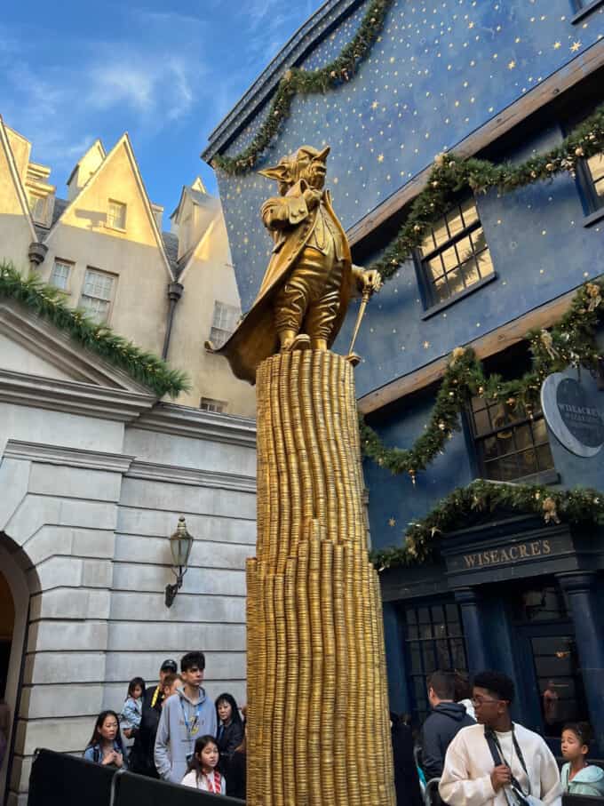 An image of a goblin statue in front of the Gringott's Bank ride at the Wizarding World of Harry Potter in Orlando.