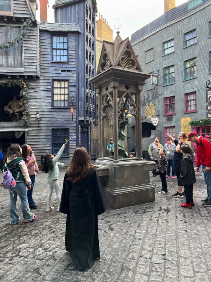 An image of kids using wands at Harry Potter World.