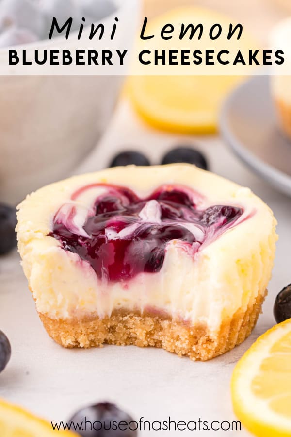 A mini lemon blueberry cheesecake with a bite taken out of it with text overlay.