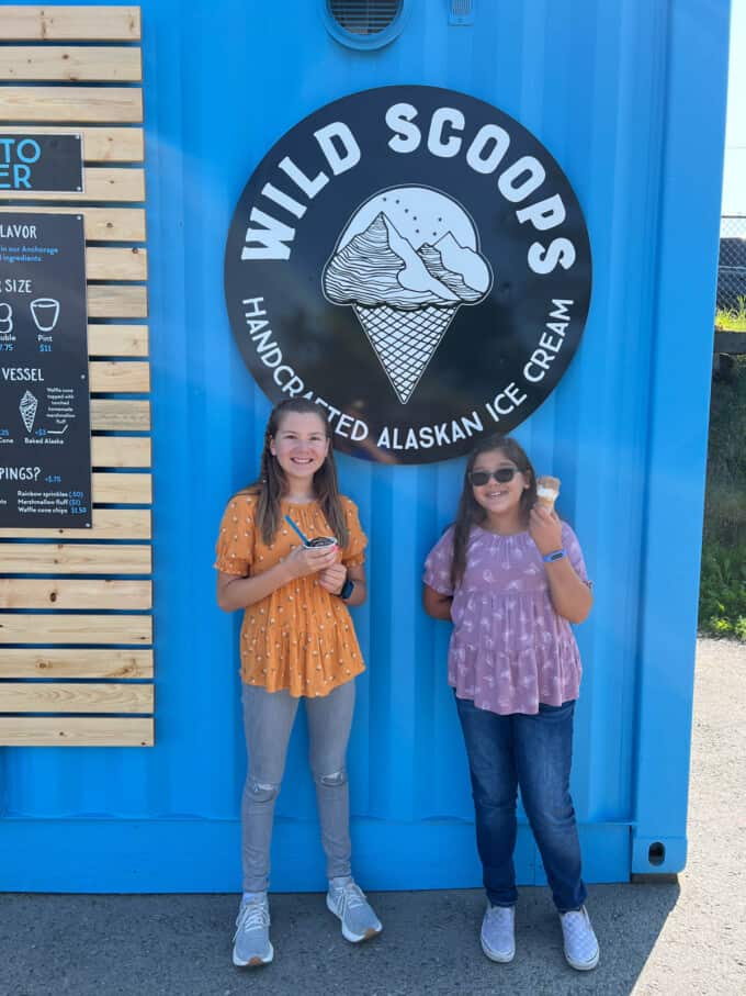 Kids holding ice cream cones in front of the Wild Scoops sign in Anchorage, Alaska.