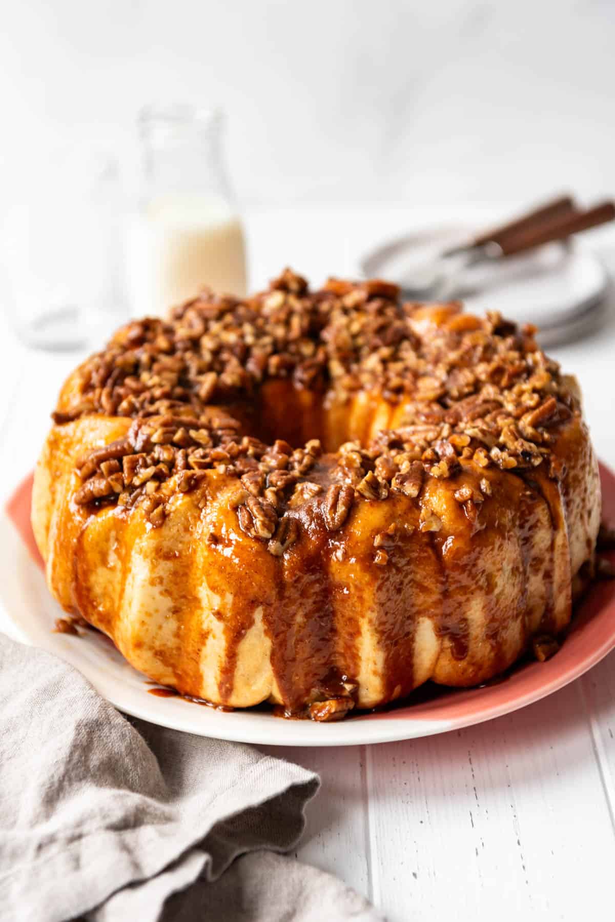 An image of caramel pecan monkey bread on a serving plate.