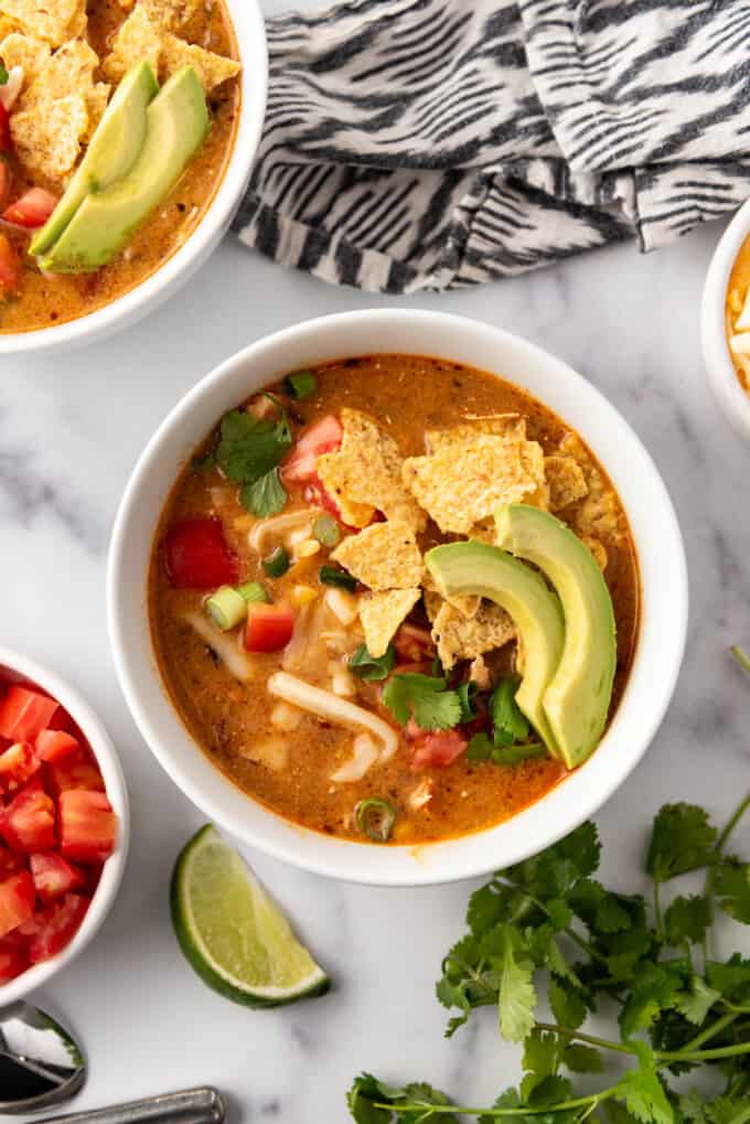 An overhead image of a bowl of chicken enchilada soup.