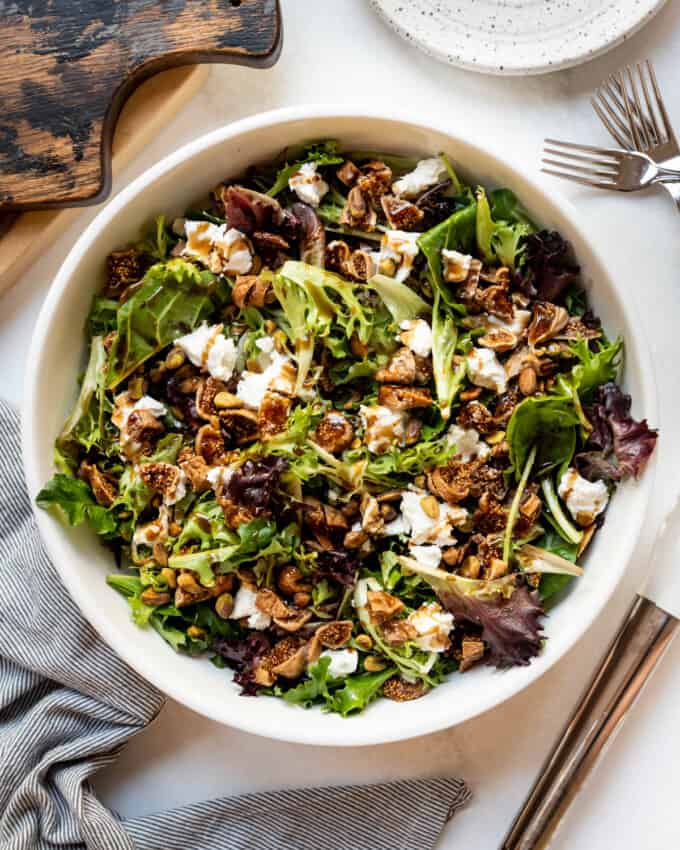 A mixed greens salad with dried fig, pistachio, goat cheese, and an easy balsamic vinaigrette dressing.