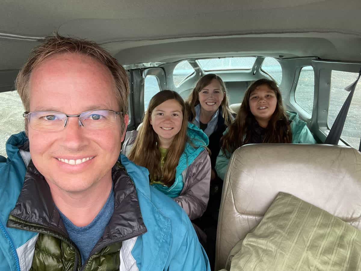 A family taking a selfie in a small bush plane in Alaska.