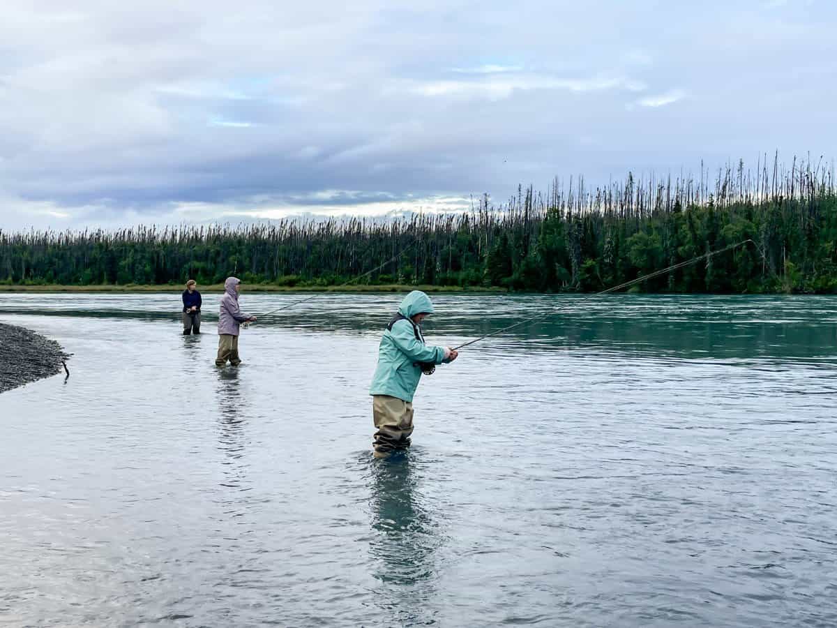 A mom and two daughters fishing on the Kenai River.