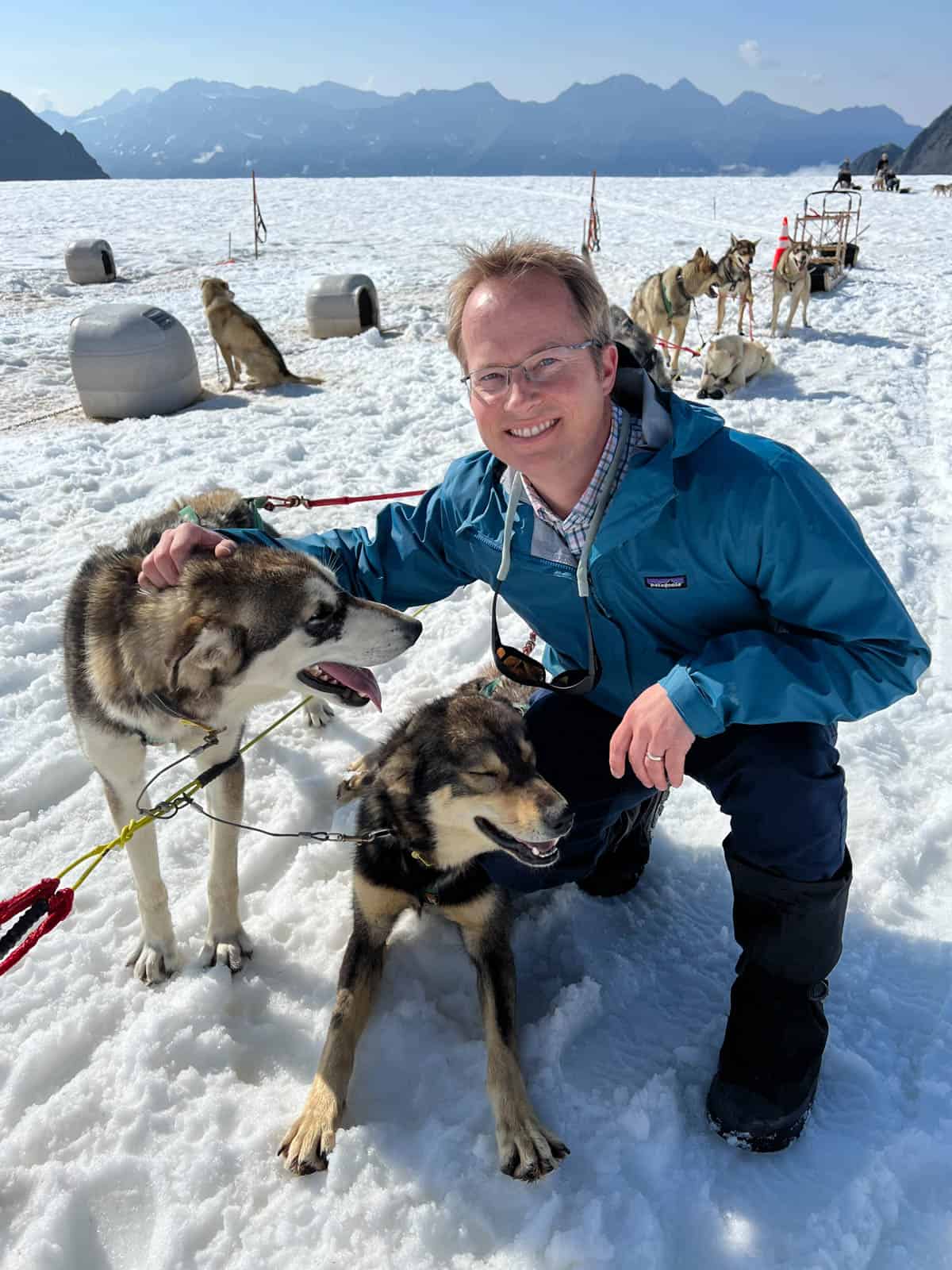 A man with sled dogs on the Knik Glacier in Alaska.