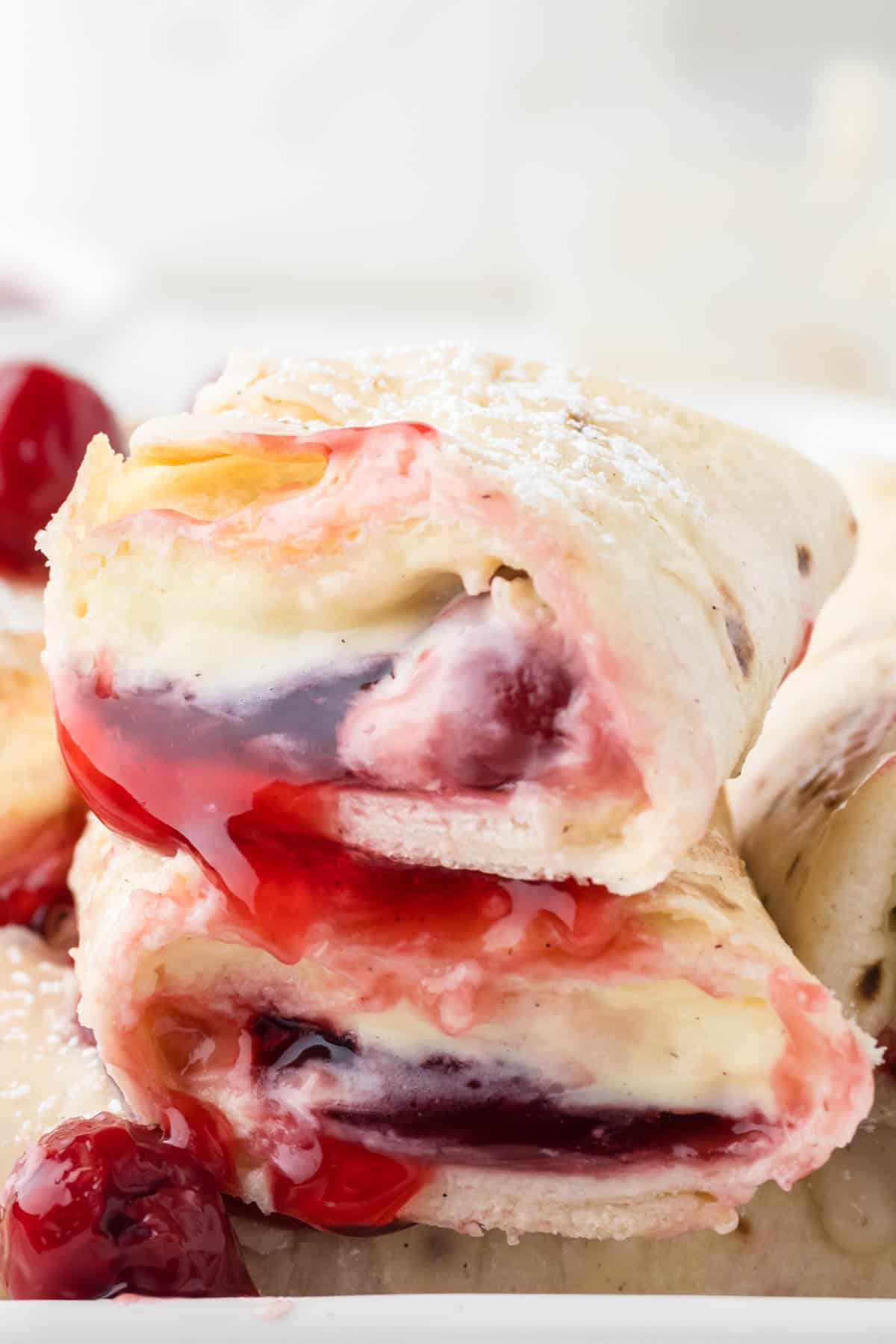 A close image of cherry cheesecake filling in crispy tortilla shells.