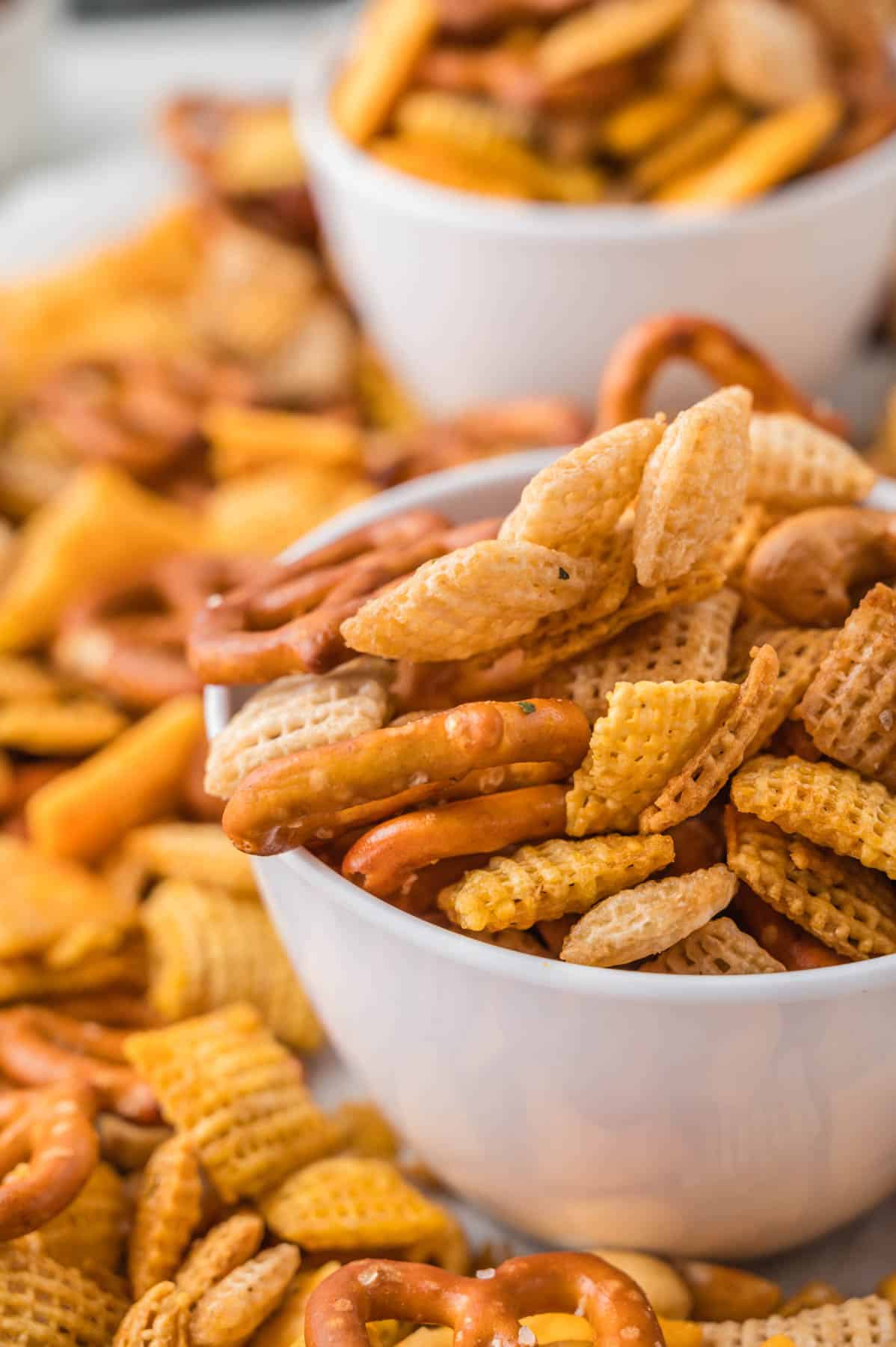 A close up side angle of a bowl of Chex mix.