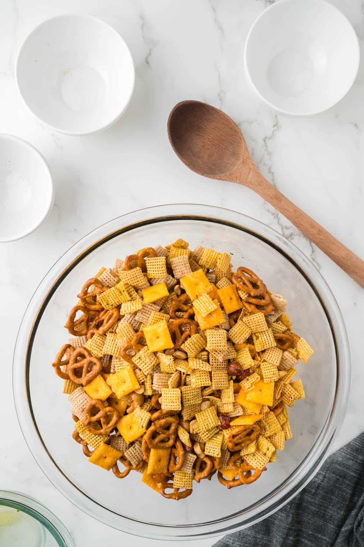 Chex mix ingredients tossed together in a large bowl.