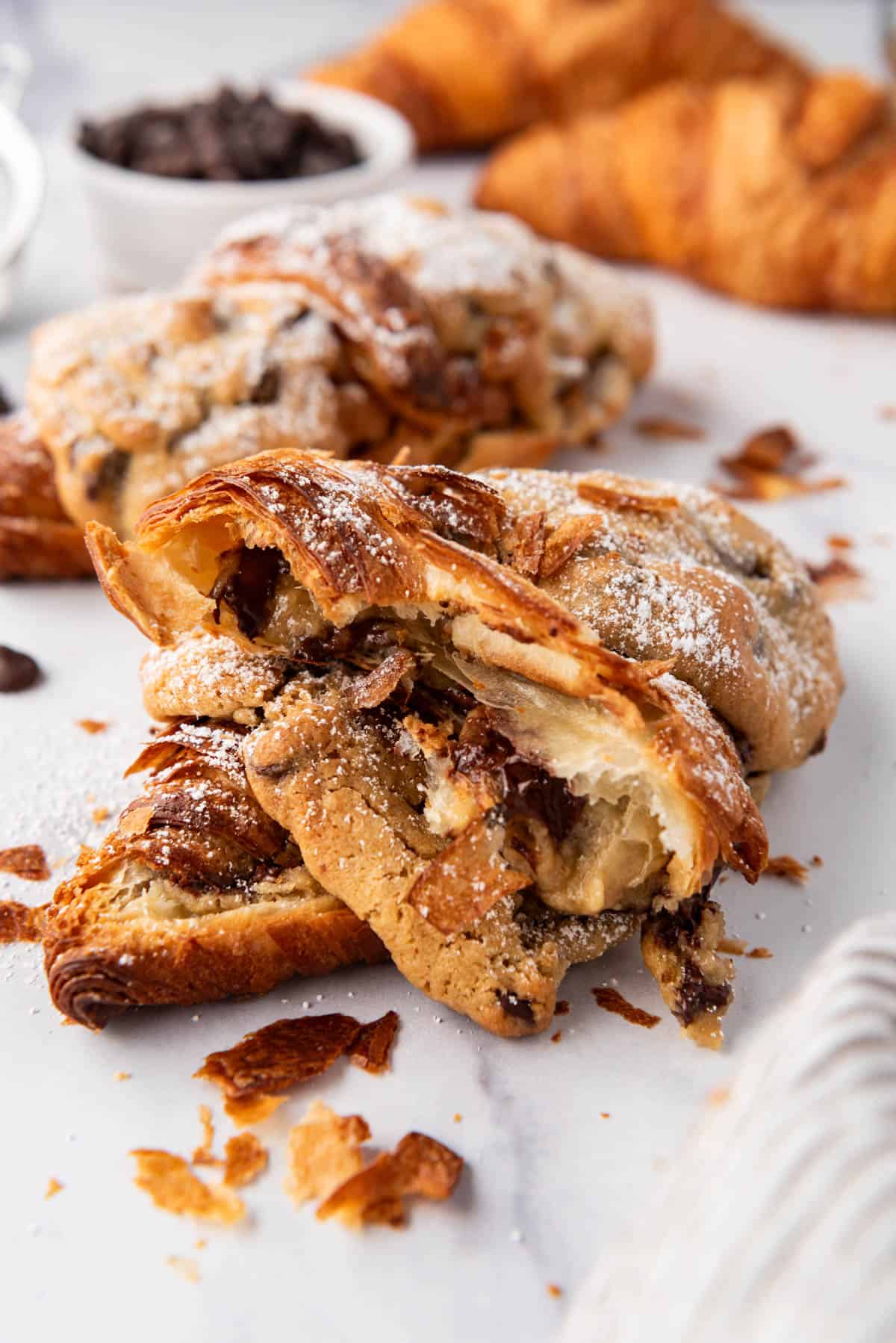An image of a flaky cookie croissant that has been torn in half.
