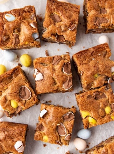 A close image of blondies with Cadbury mini eggs with a crackly, shiny top.