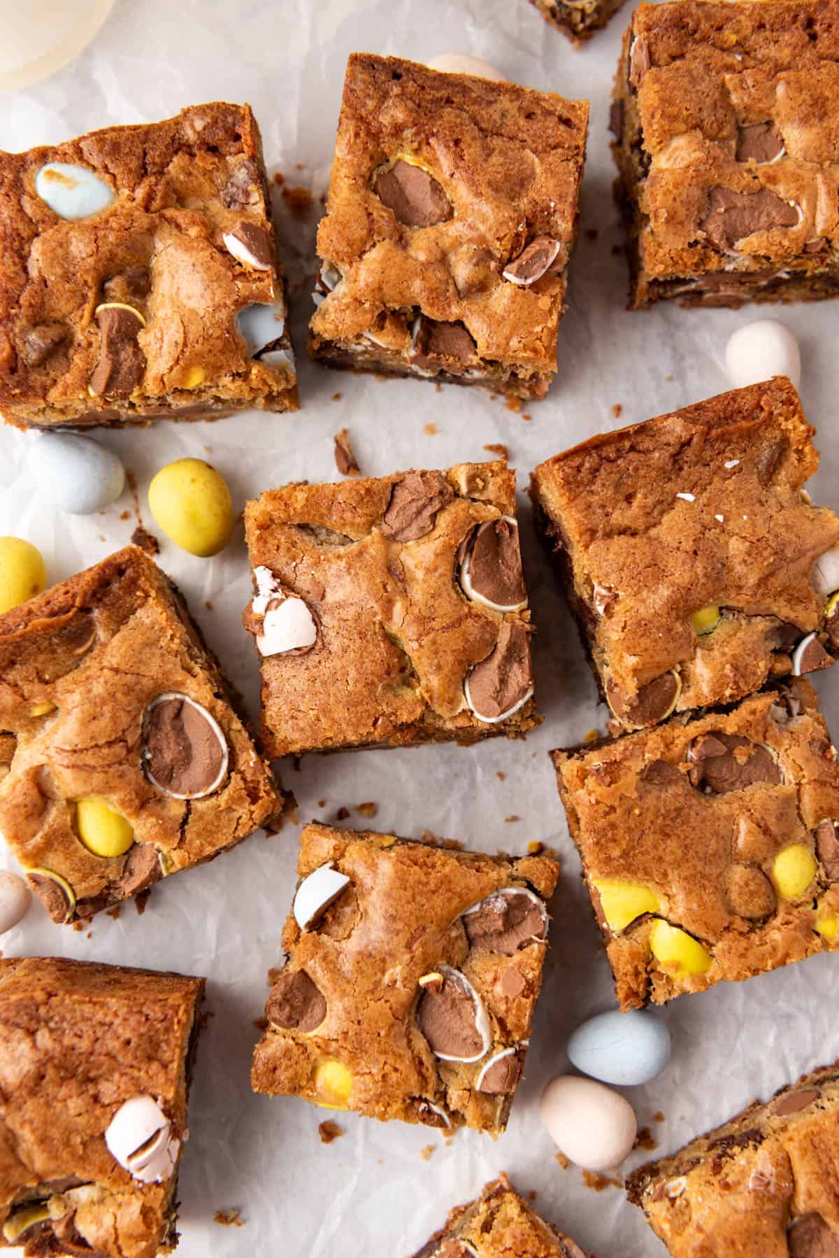 A close image of blondies with Cadbury mini eggs with a crackly, shiny top.