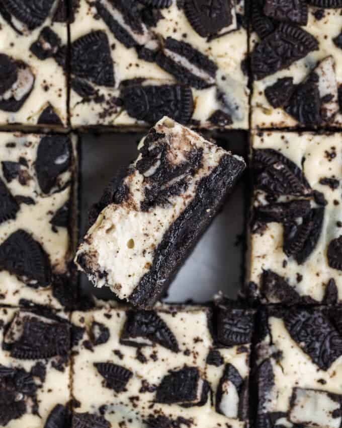 An overhead image of oreo cheesecake bars with one bar turned on its side.