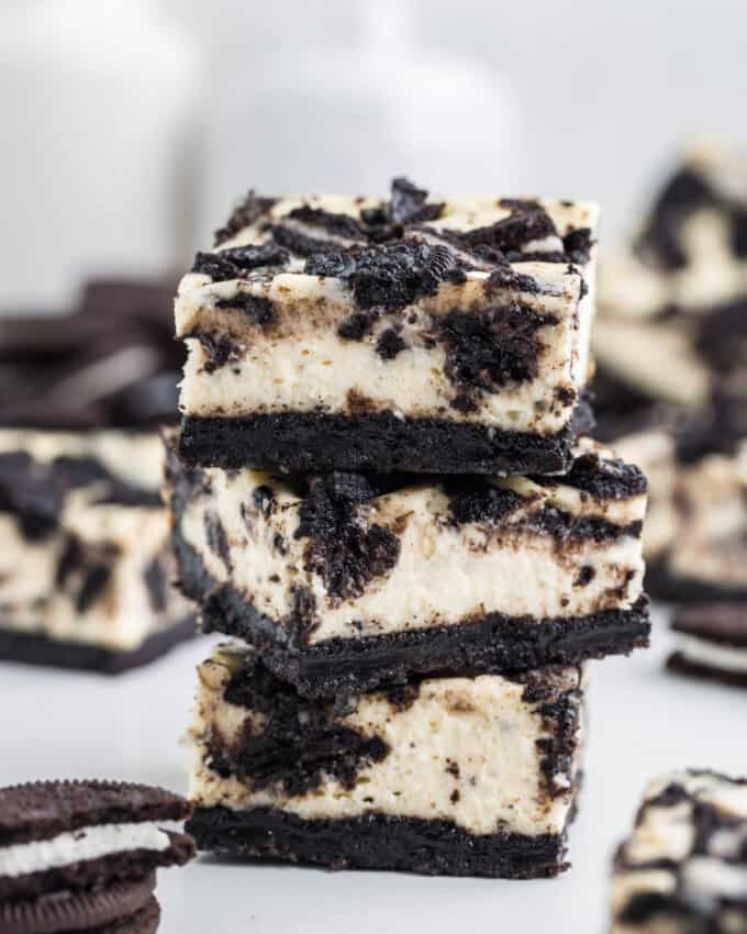 Three stacked Oreo cheesecake bars.