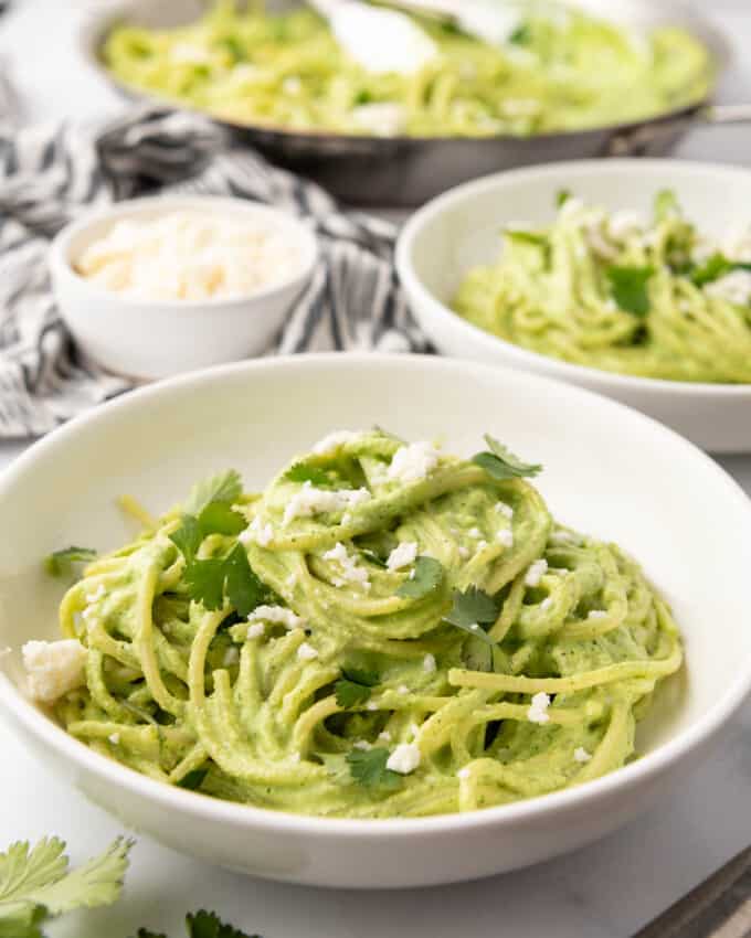 Bowls of Mexican spaghetti with creamy green poblano sauce.