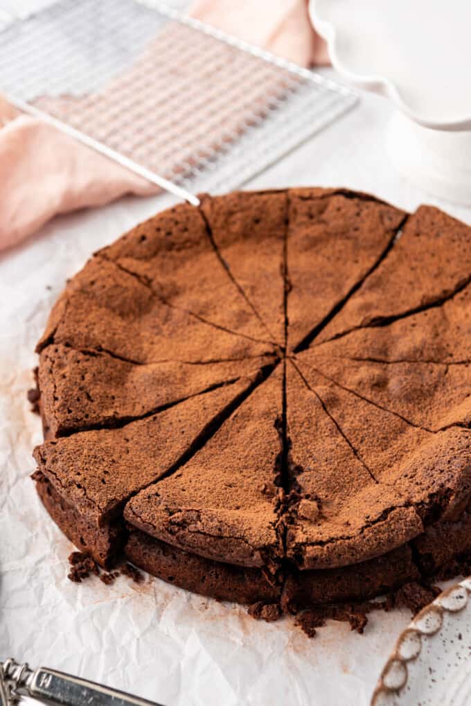 An image of a flourless chocolate cake that has been sliced into individual servings.