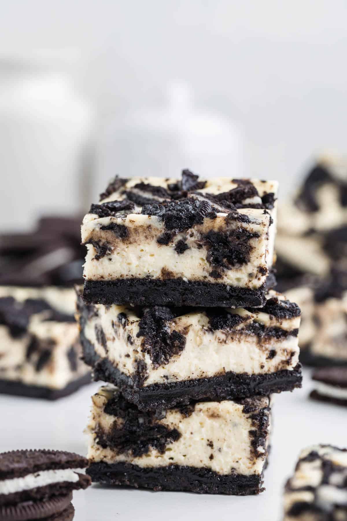 Three stacked Oreo cheesecake bars.