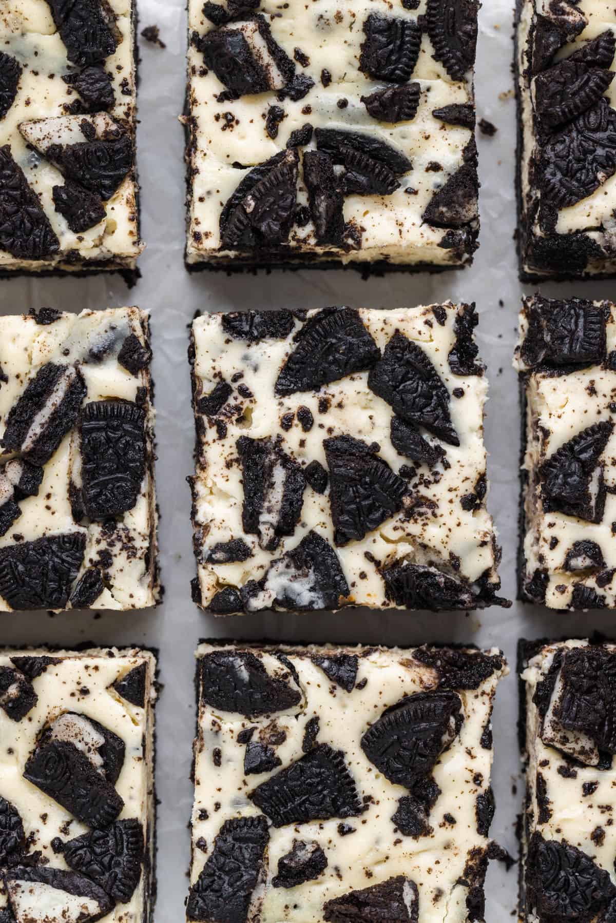 An overhead image of Oreo cheesecake bars cut into squares.