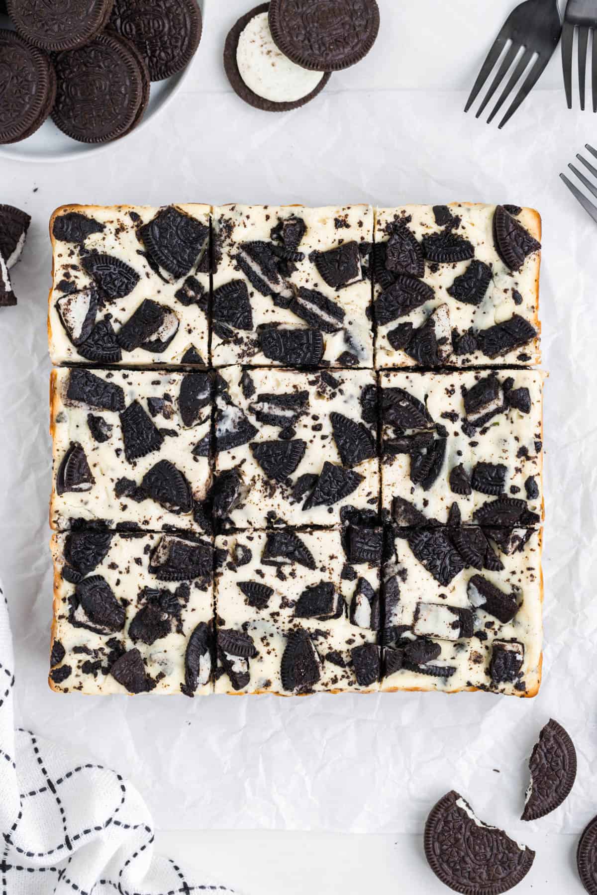 Baked and cooled Oreo cheesecake bars that have been cut into squares.