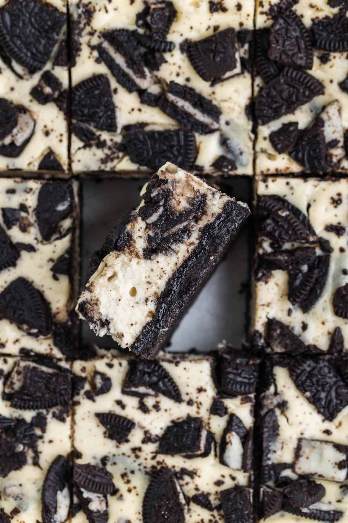 An overhead image of oreo cheesecake bars with one bar turned on its side.