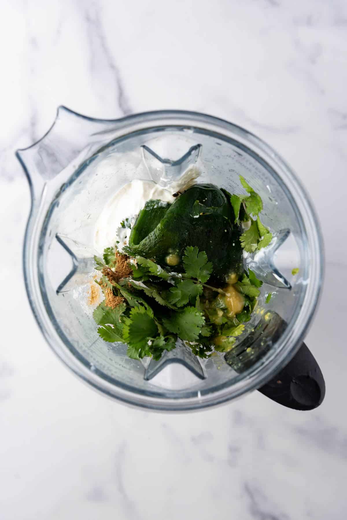 Ingredients for a creamy poblano sauce in a blender.