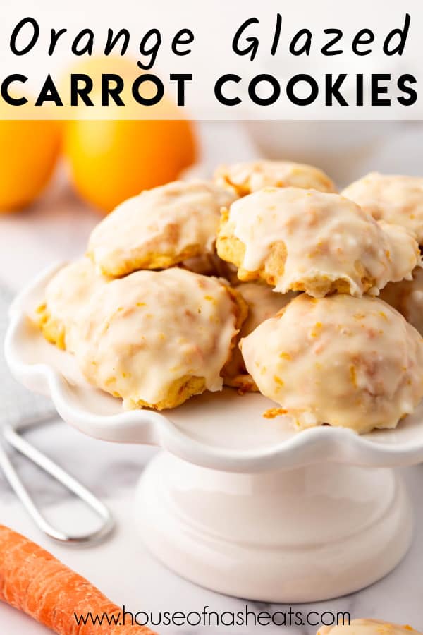 Orange glazed carrot cookies on a white cake stand.