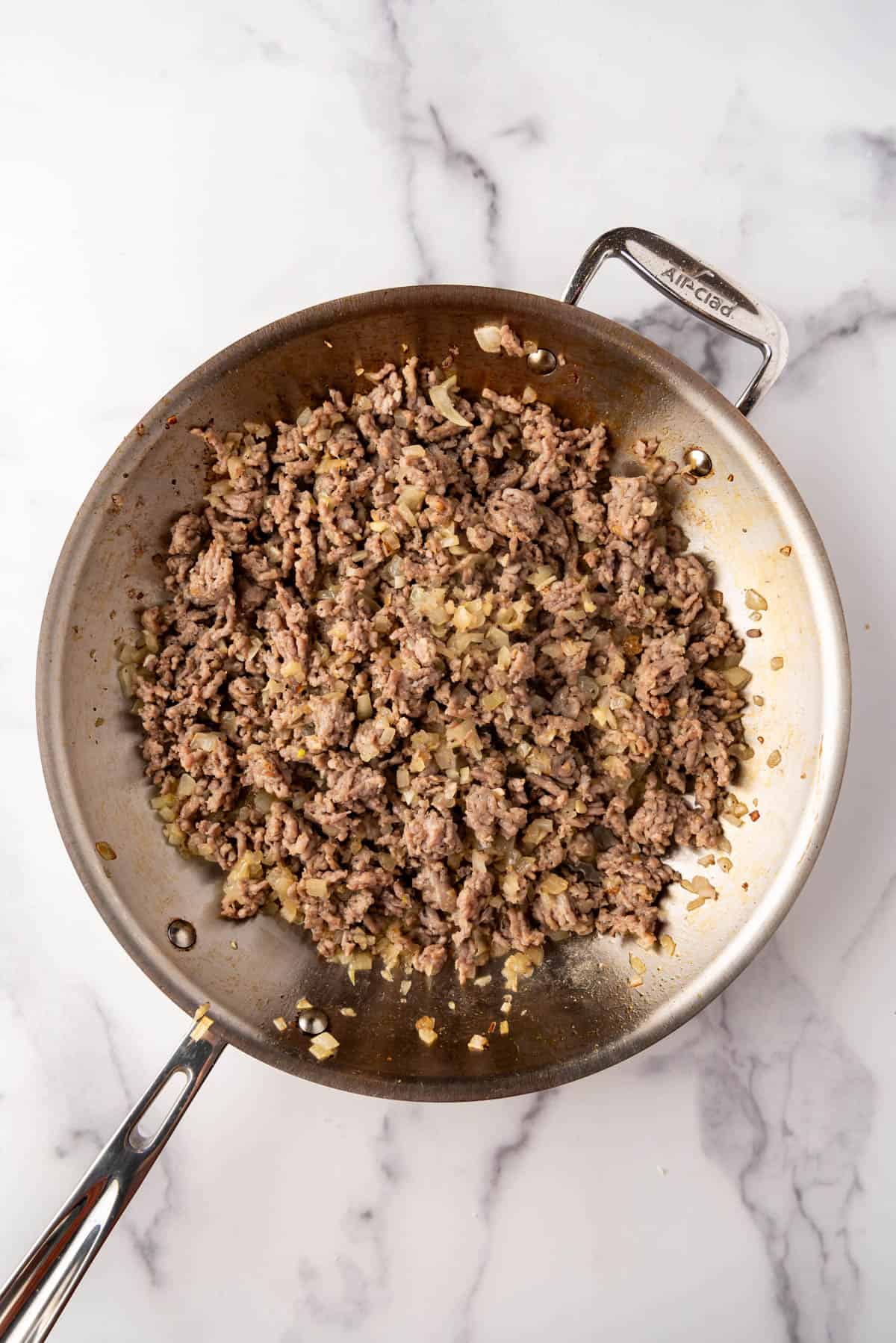 Browned Italian sausage in a large skillet.