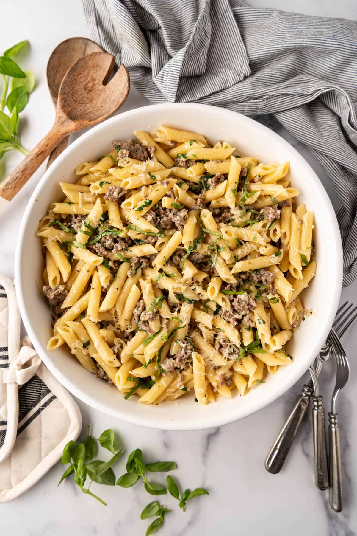 An overhead image of a large bowl of creamy sausage pasta.