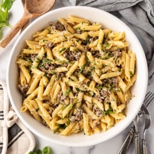 An overhead image of a large bowl of creamy sausage pasta.