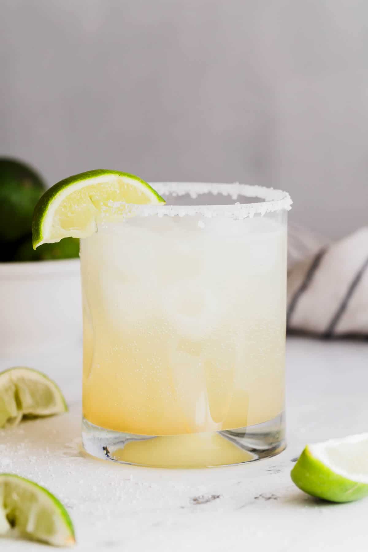 A margarita mocktail with a lime wedge.