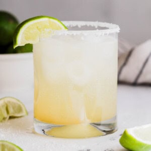 A margarita mocktail with a lime wedge.