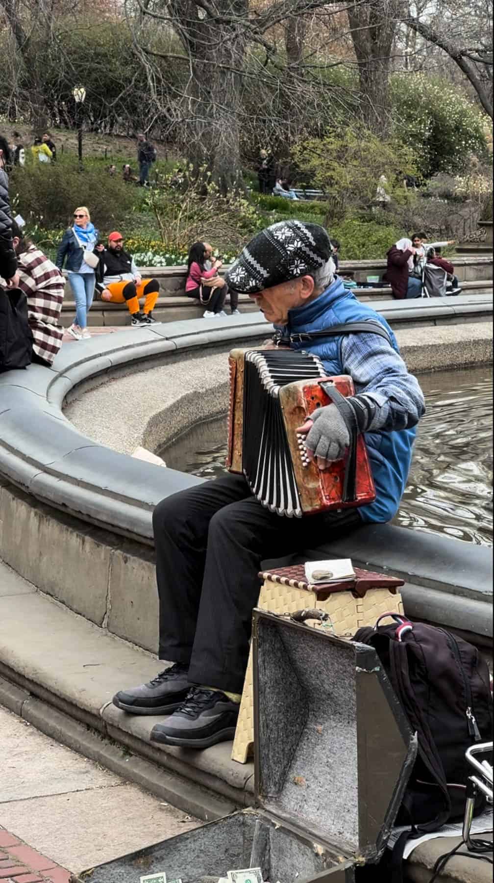 A man playing the accordion at Bethesda Fountain in Central Park.