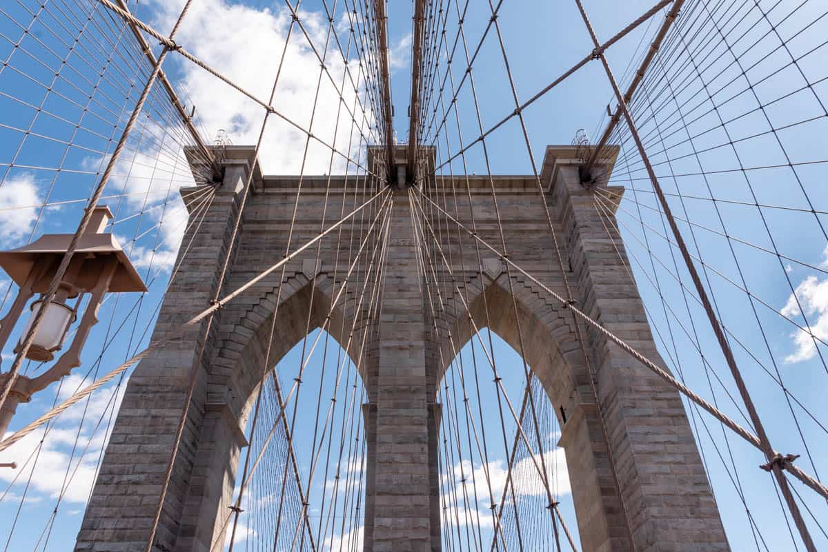 An image of the Brooklyn Bridge cables and tower.