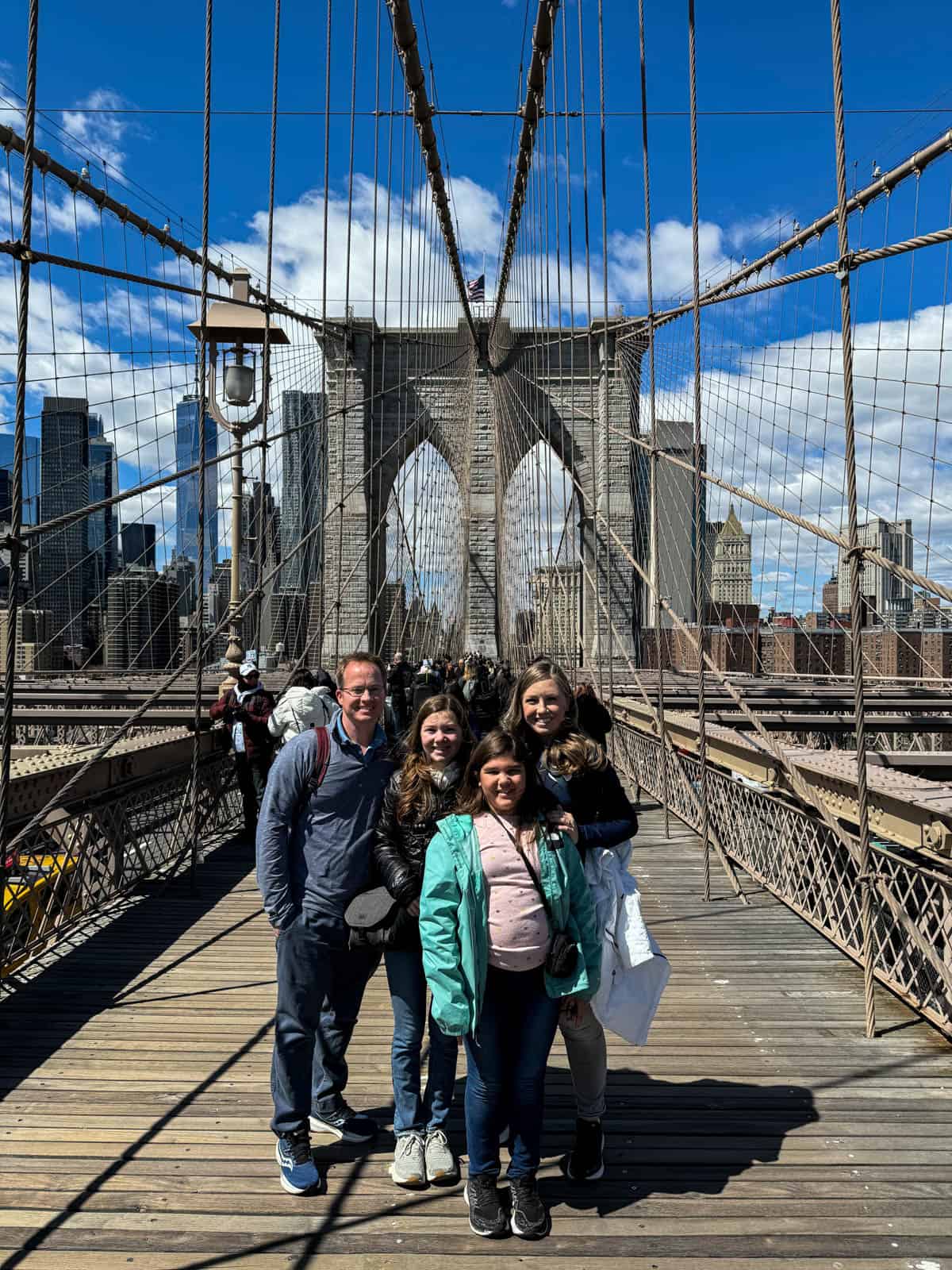 A family of four on the Brooklyn Bridge.