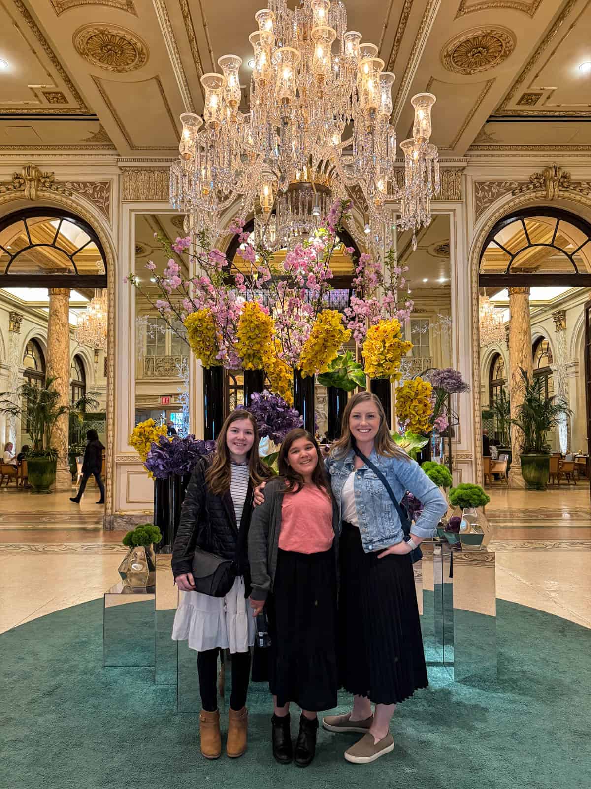 A mom and two daughters in the lobby of the Plaza Hotel in NYC.