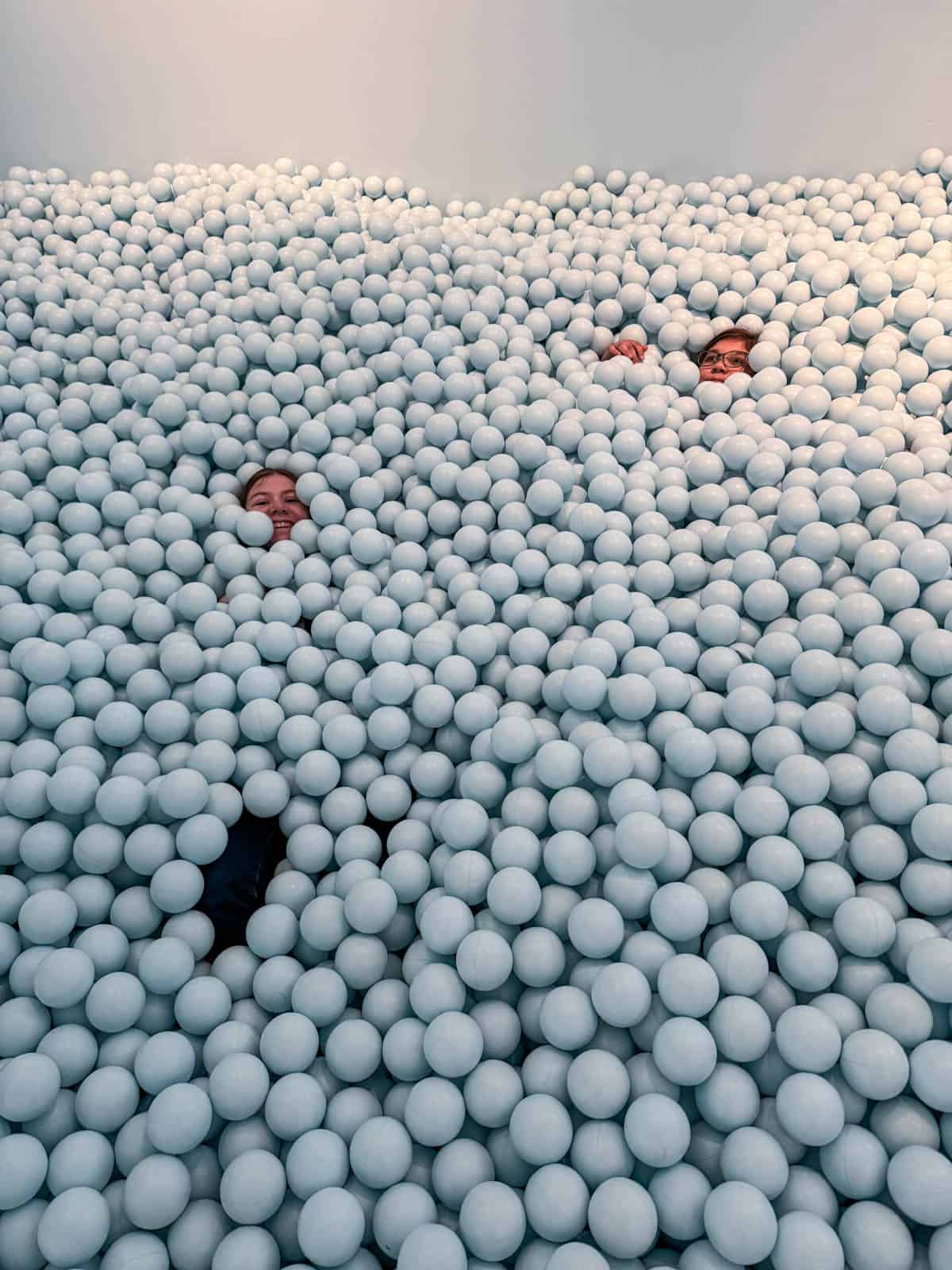 Kids buried in a ball pit.