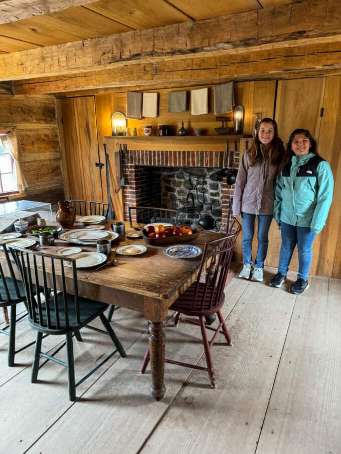 Two kids in the Smith family log home in Palmyra, New York.