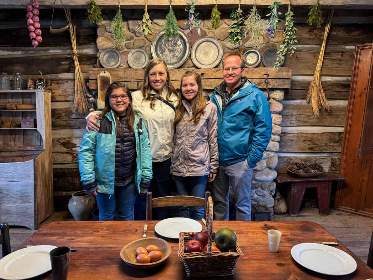 An image of a family of four in the Peter Whitmer farm kitchen.