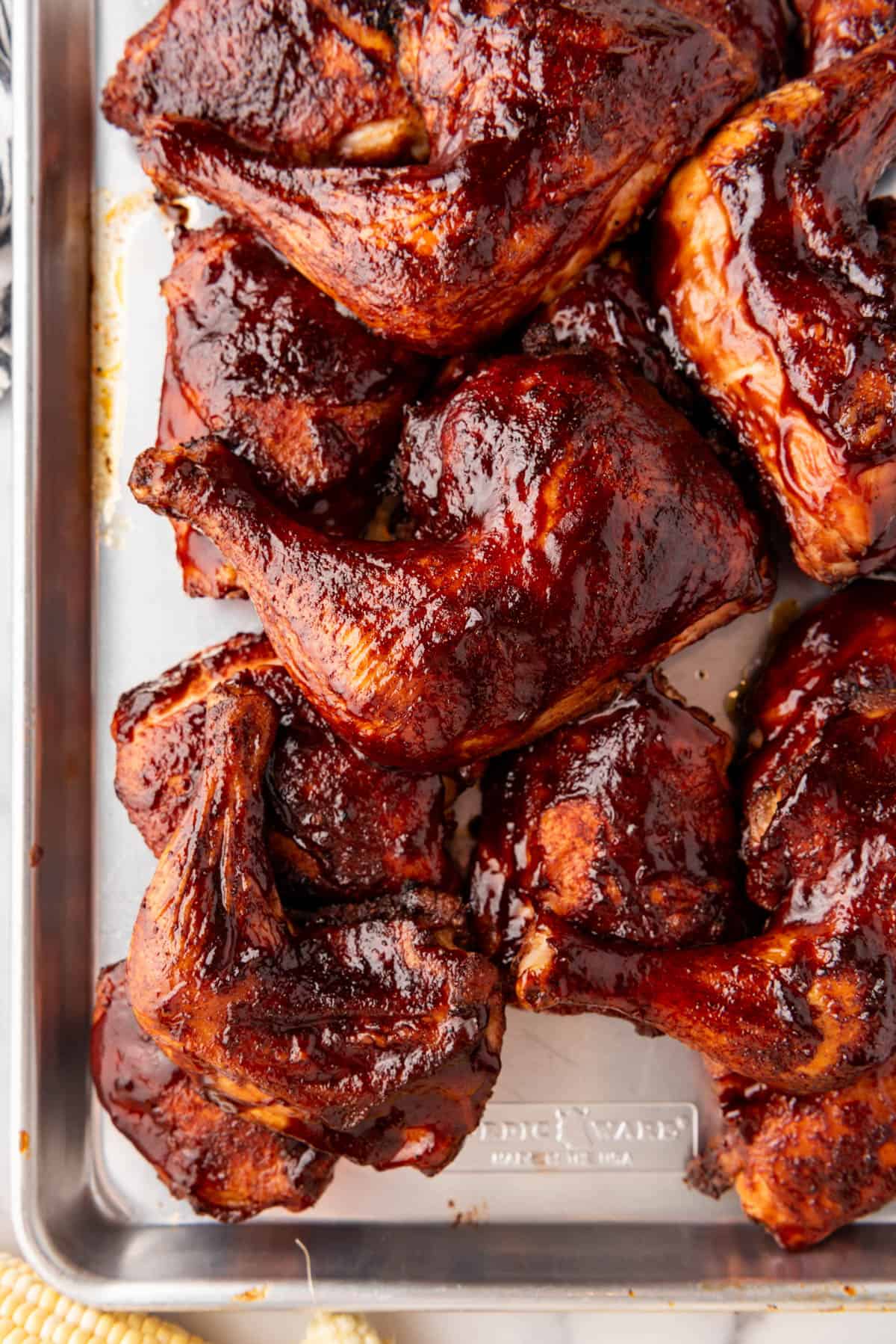 Another image of smoked chicken thighs on a baking sheet.